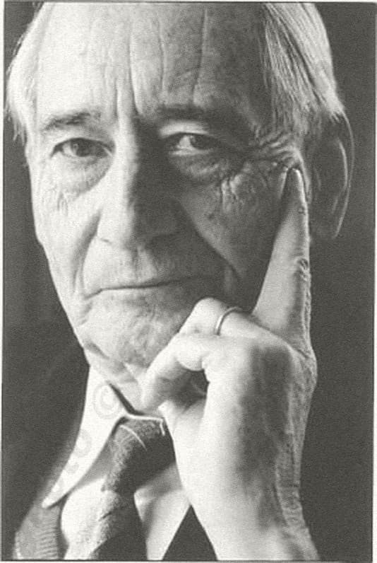 Black-and-white portrait of Jean Pictet in old age, hand against his cheek, looking at the camera.